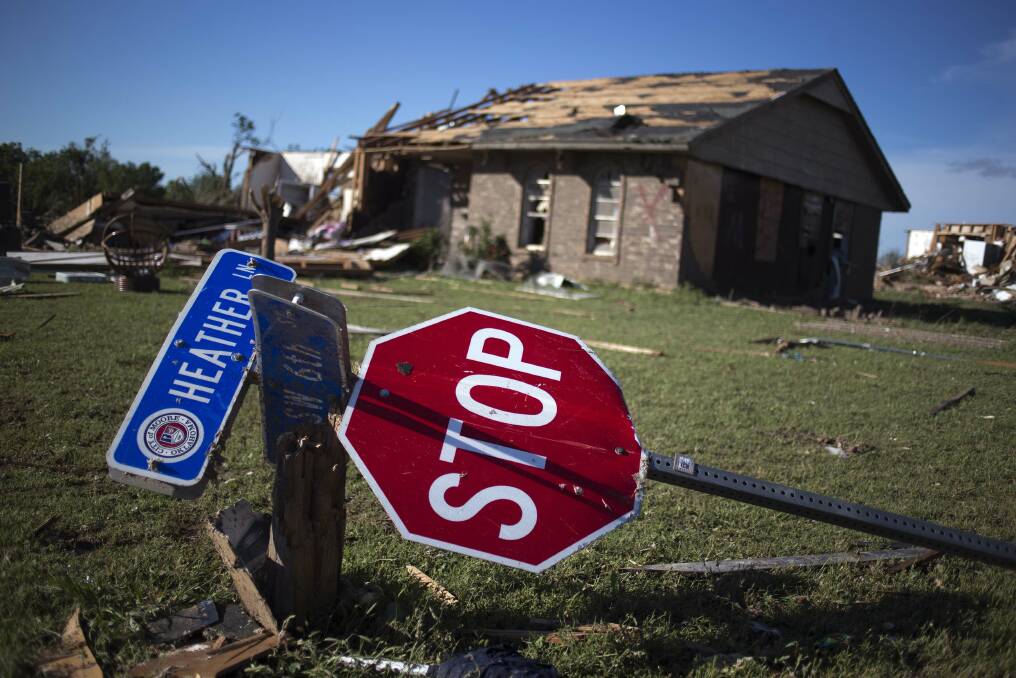 A street sign lie in the yard of a home a day after a tornado devastated the town Moore, Oklahoma, in the outskirts of Oklahoma City on May 21, 2013. Photo: REUTERS/Adrees Latif