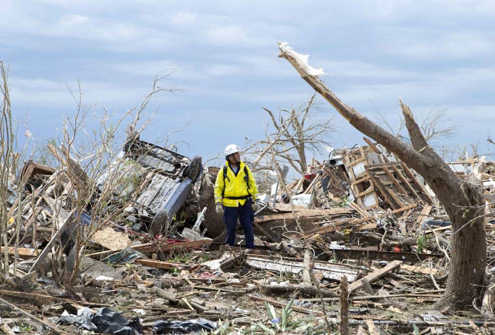 A recovery worker surveys the destruction in a neighborhood in Moore, Oklahoma May 21, 2013. Photo: REUTERS/Richard Rowe