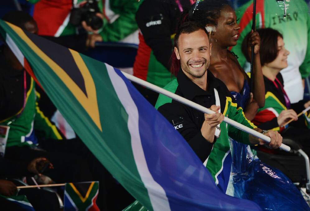 Oscar Pistorius carries the South African flag during the Opening Ceremony of the London 2012 Paralympics on August 29, 2012. Photo by Gareth Copley/Getty Images
