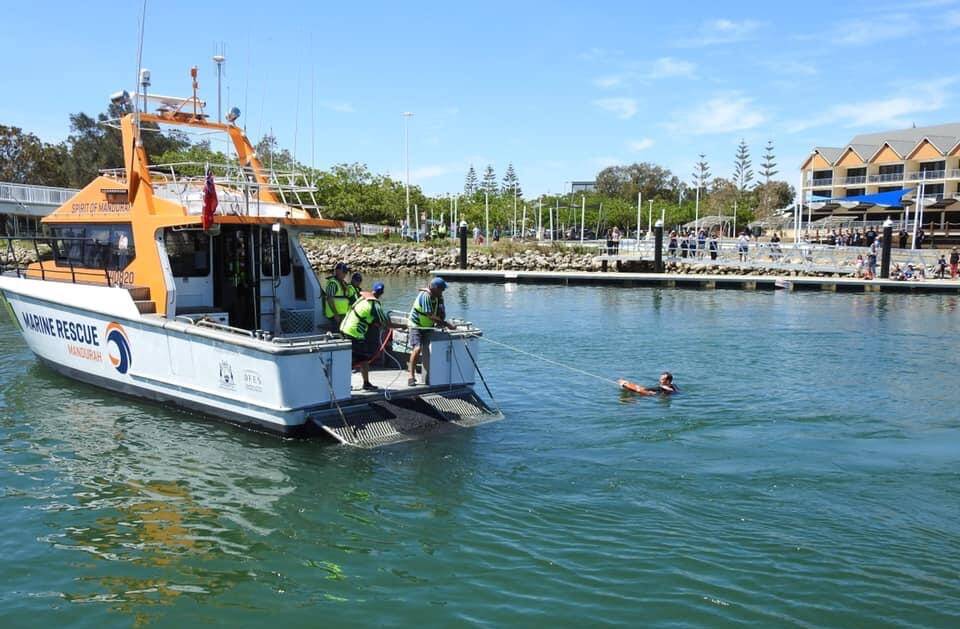 HELP HAS ARRIVED: Mandurah Marine Rescue helping Mayor Williams out of the water in one of their rescue missions. Photo: Rhys Williams.