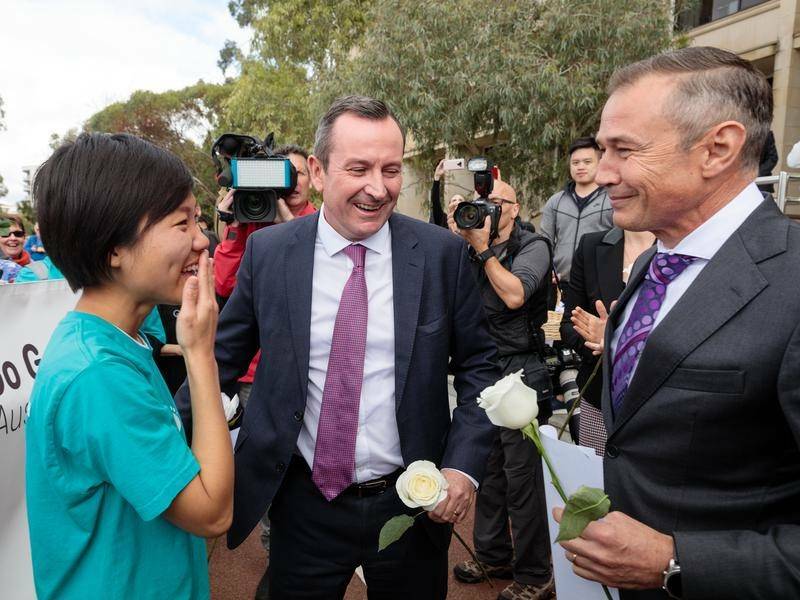 EMOTIONAL: Health Minister Roger Cook (right) in 2019 after the WA legalisation of voluntary assisted dying passed. Photo: AAP.
