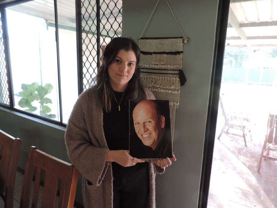 HEARTBROKEN: Milly Cooney with a picture of her stepfather. Photo: Samantha Ferguson.
