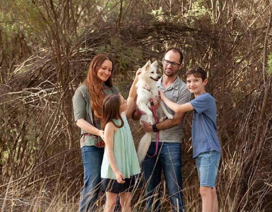 Megs, Sophie, Simon and David Collins posing with their pup. Picture by Cathryn Jupp.