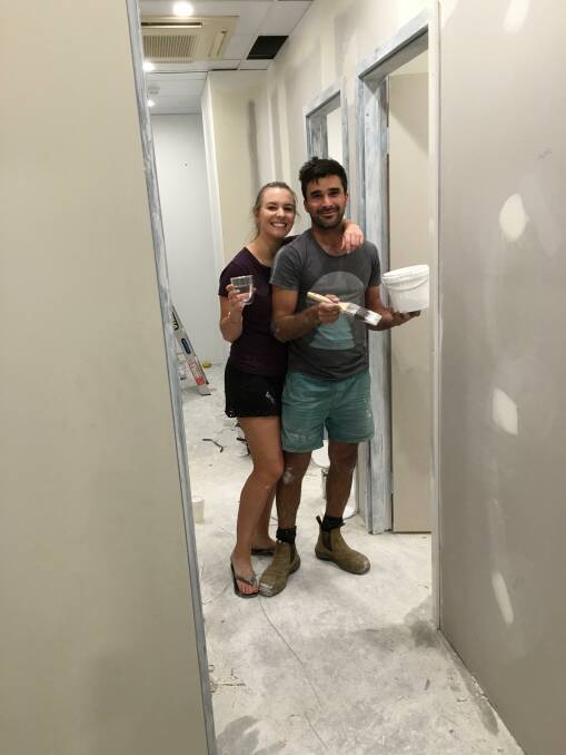 HARD WORK: Hannah and her husband Jake working to renovate Eco Spa. Photo: Supplied.