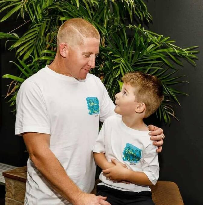 Leigh Rose and his son wearing Bali Fest promotional shirts. Photo: Supplied.