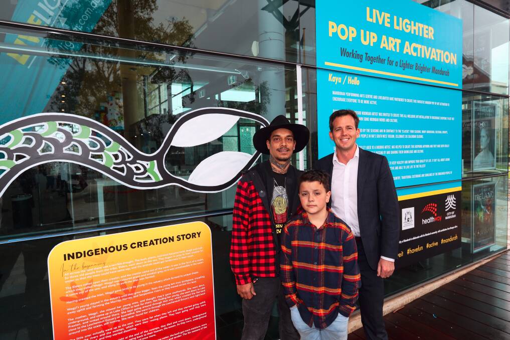 FAMILY: Daniel, his son James and Mayor Rhys Williams in front of their MANPAC mural. Photo: Mark Labrow.