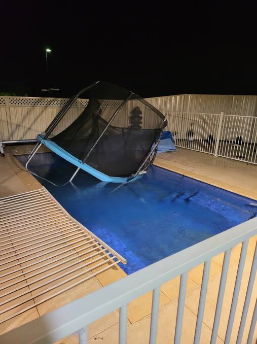 JUST DROPPING IN: One Mandurah local got the surprise of his life when he'd found a stray trampoline had blown into his pool. Picture: Steven Lawson.