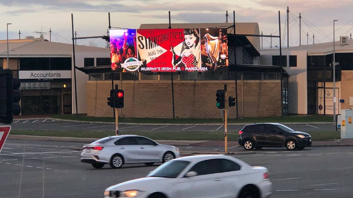 BUILDING EXCITEMENT: Promotional billboard for The Sinnermatics' Murphy's gig which is driven past by 60,000 people per day. Picture: Supplied.