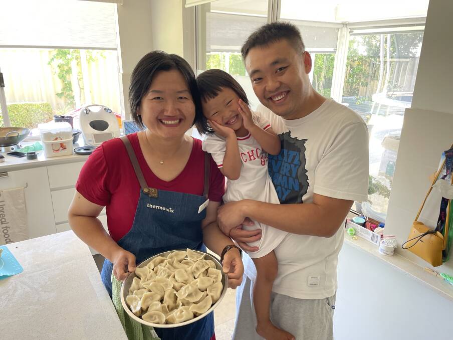 A family affair: Yina Jia makes her Chinese pork and spring onion dumplings with help from her husband, Ti Zhao, and three-year-old daughter, Mia. Picture: Pip Waller 