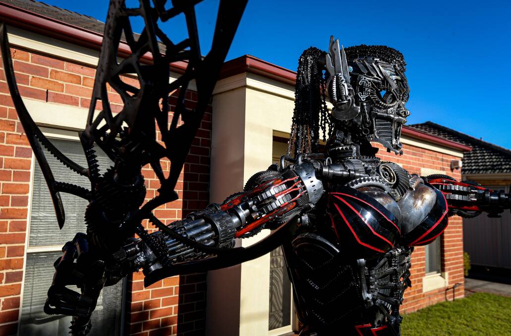 NOT QUITE A LAWN GNOME: The large metal structure out the front of the Albury home is made out of scrap metal by artist Michael Laubli.