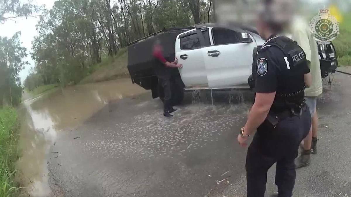 A man and his dog were saved by authorities after he allegedly drove into flood waters in Central Queensland on Tuesday. 