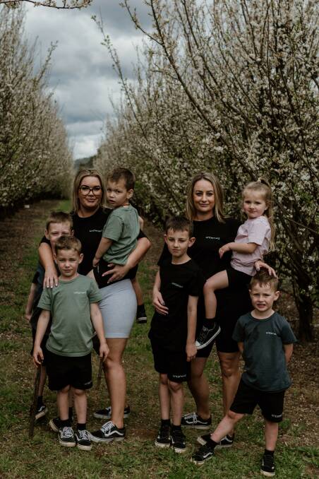Bronte Densley and her sister-in-law Nicole Moscardini with their children, wearing t-shirts from their brand, Untamed the Label. Picture supplied.