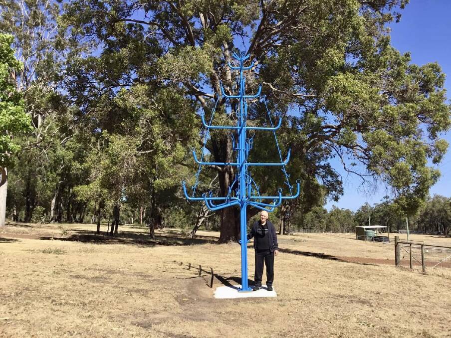 John French secretly built and erected a large blue metal tree for his son-in-law. Picture supplied.