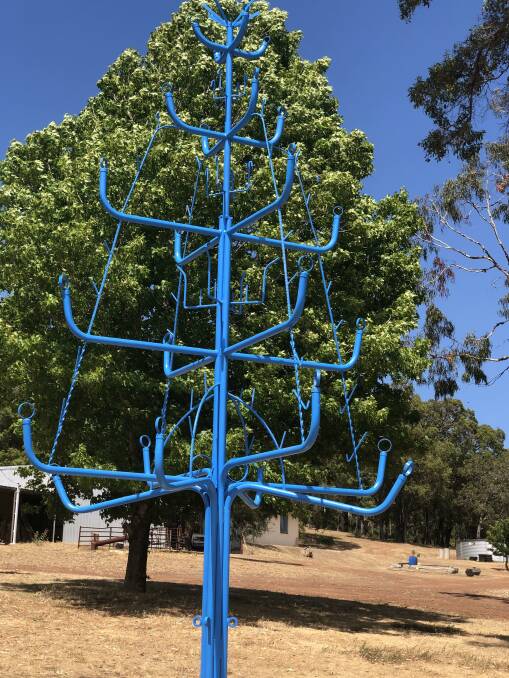 John French secretly built and erected a large blue metal tree for his son-in-law. Picture supplied.