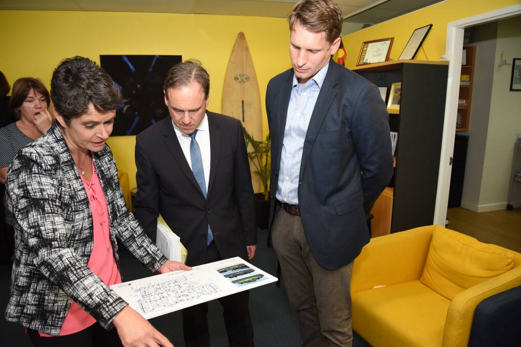 GP down south's Eleanor Britton shows plans for the PYMS Youth Health Hub to federal health minister Greg Hunt and Canning MP Andrew Hastie. Photo: Marta Pascual Juanola.