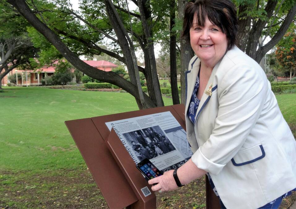 Interactive: Shire President Cr. Reid using a QR reader on the new Pathways to Pinjarra Heritage Trail