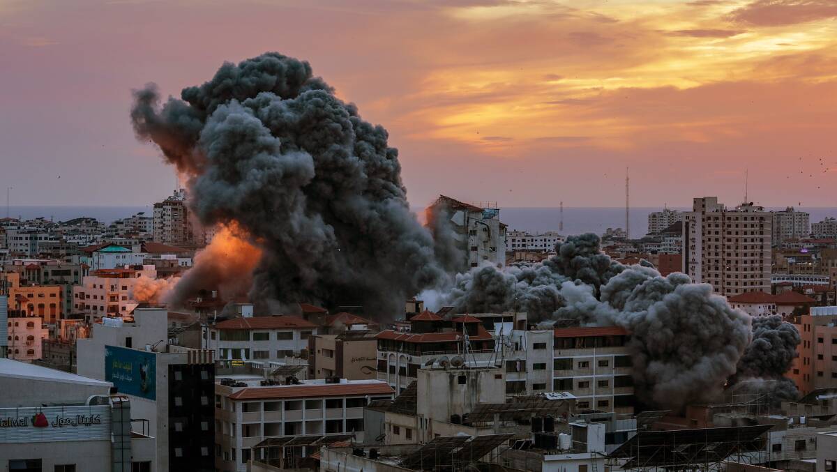 Smoke rises after Israeli warplanes targeted the Palestine tower in Gaza City earlier this month. Picture AAP