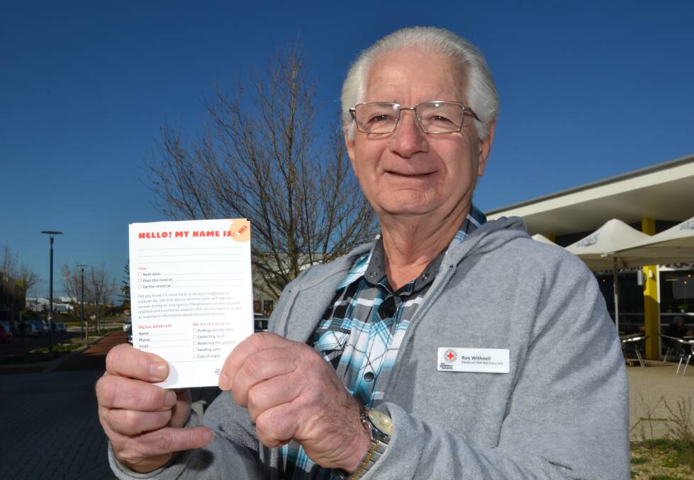 Helping others: Australian Red Cross volunteer Ron Withnell with the card he has dropped to his neighbours, introducing himself. Photo: Carla Hildebrandt. 