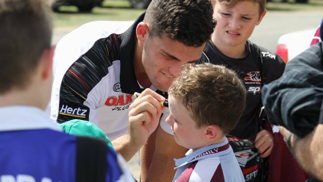 Nathan Cleary signs the forehead of Austin Chenhall at a gala day in Bathurst last year. Photo: Bradley Jurd