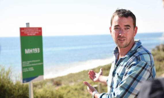 Rick Gerring in front of a Beach Emergency Number (BEN) sign. Photo: Marta Pascual Juanola.