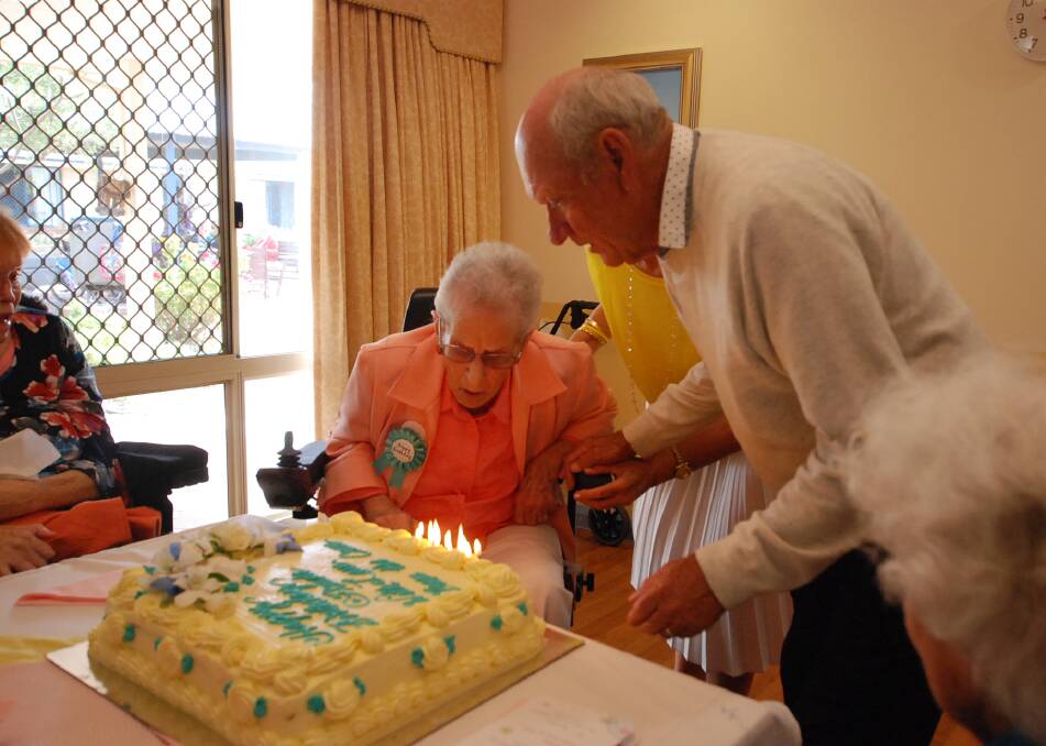 Frieda Sullivan blowing out her candles with the help of her son Colin. Photo: Caitlyn Rintoul. 