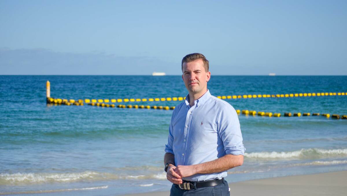 Shark barrier: Dawesville MP Zak Kirkup inspecting the shark enclosure at Coogee beach, north of Mandurah, similar to the barrier he proposed for Falcon. Photo: Supplied.