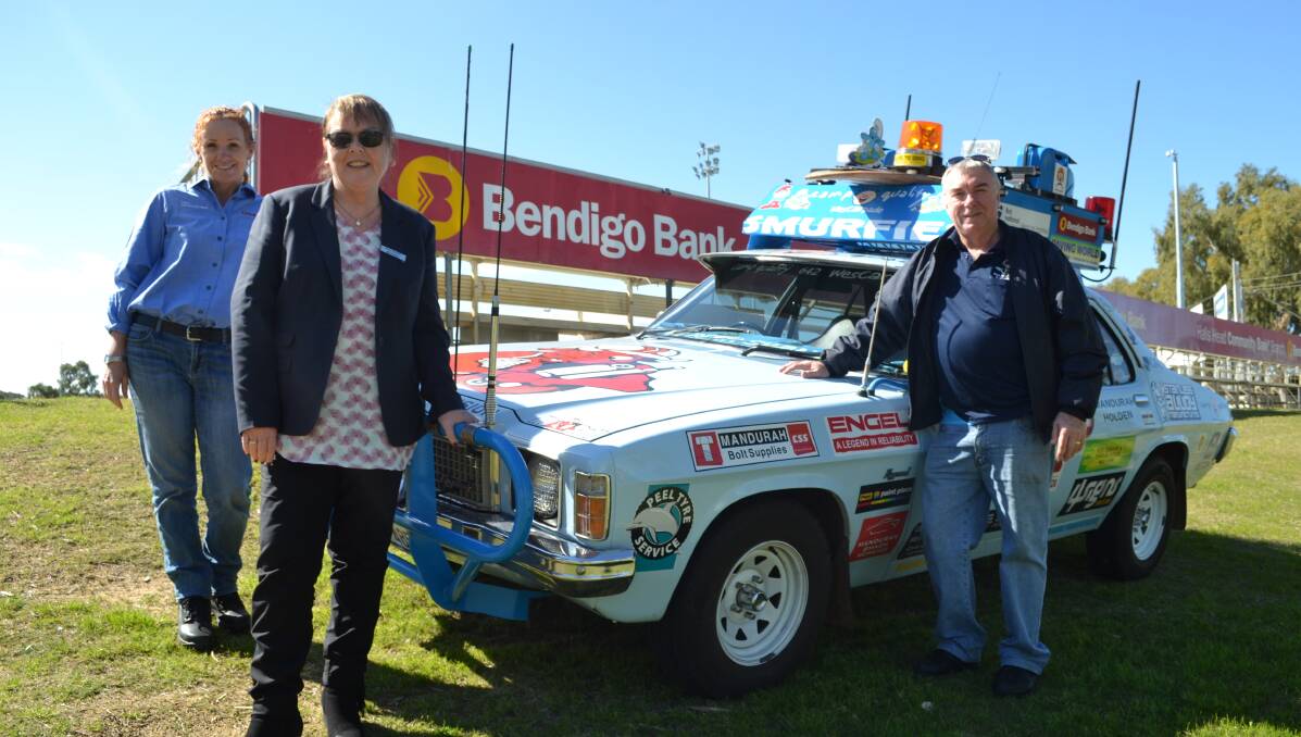 Smurf's up: Bendigo Bank's Donna Bamkin and Fiona Bell with Mitch Vickers. Photo: Cam Findlay.