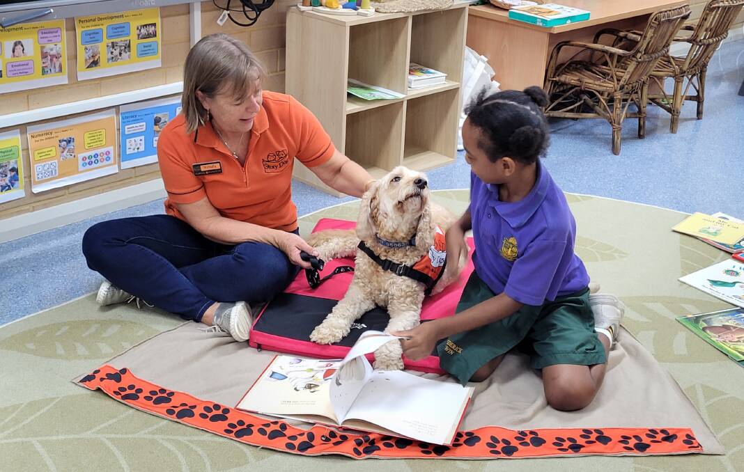 Komila Urgine says she enjoys her time reading to Biscuit. Photo: Supplied.