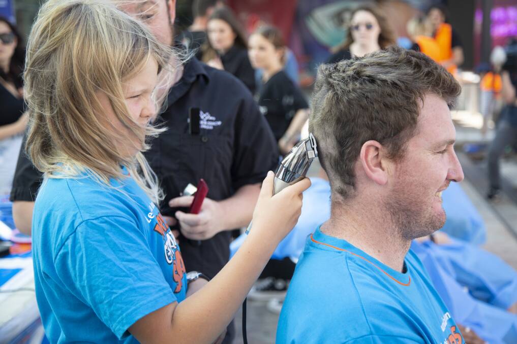 Ruby shaves the head of Perth's Hit 92.9 FM's breakfast host, Xavier to raise funds for Leukaemia. Photo: Supplied.