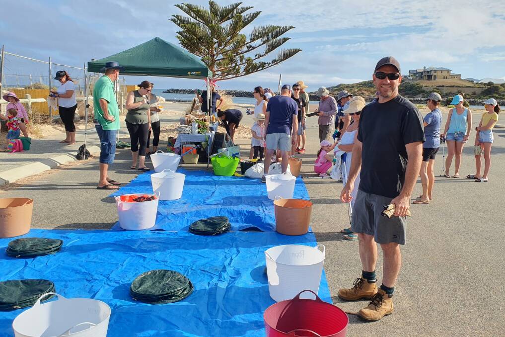 Mr Burns helping clean up the beach with the Coastal Waste Warriors. Photo: Supplied.