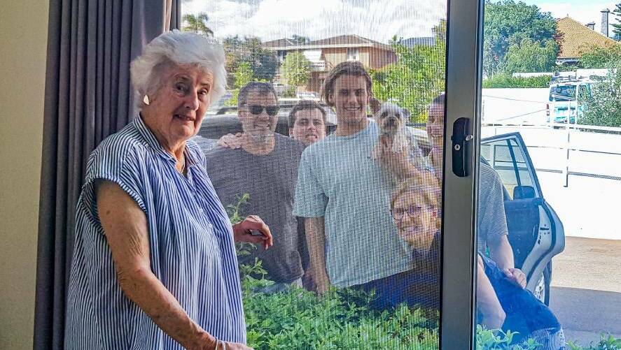 Home Instead Senior Care resident, Sue Monger is able to see her loved ones through the window. Photo: Supplied.