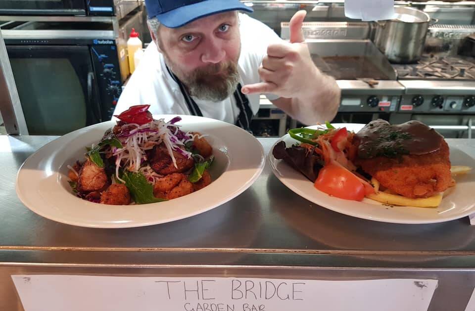 The Bridge Garden Bar chef Dave serving the first meals when the pub reopened on Saturday. Photo: Supplied.