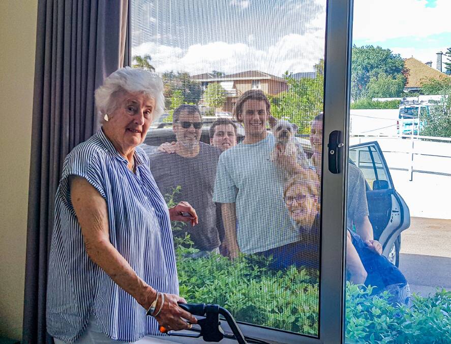 Home Instead Senior Care resident, Sue Monger is able to see her loved ones through the window. Photo: Supplied.