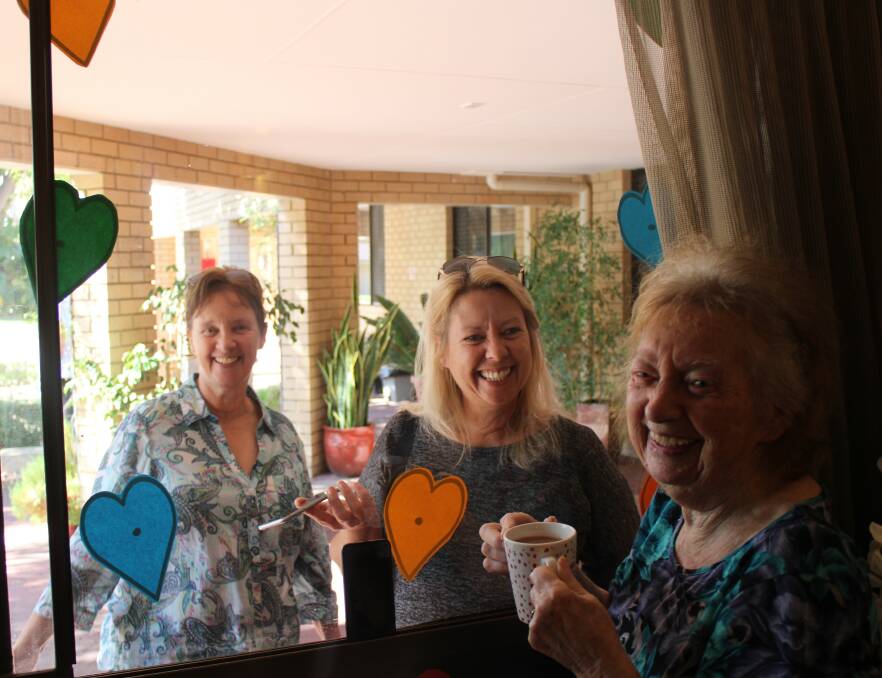 Opal Murray River Care Community resident Alice Singleton meets up with her daughters, Michele and Pauline at the 'Window of Love'. Photo: Supplied.
