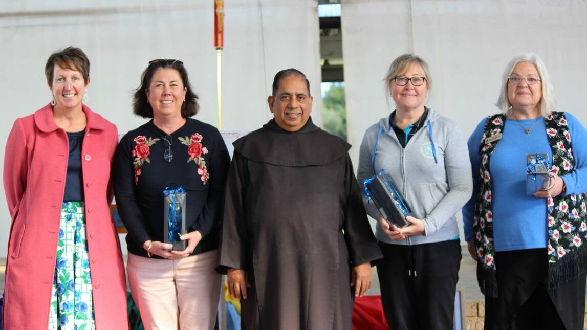 Staff who had been at the school for 10 years or more were awarded including Robyn Dixon, Elaine Pimlottand and Kathleen Hill, pictured with parish priest Father Johny and principal Miranda Swann.