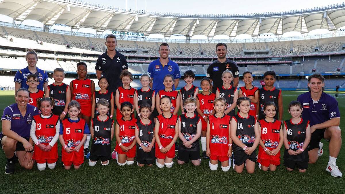 The participants gather in a training session at Optus Stadium on Thursday where they got a behind-the-scenes look at what their role will involve this Saturday.