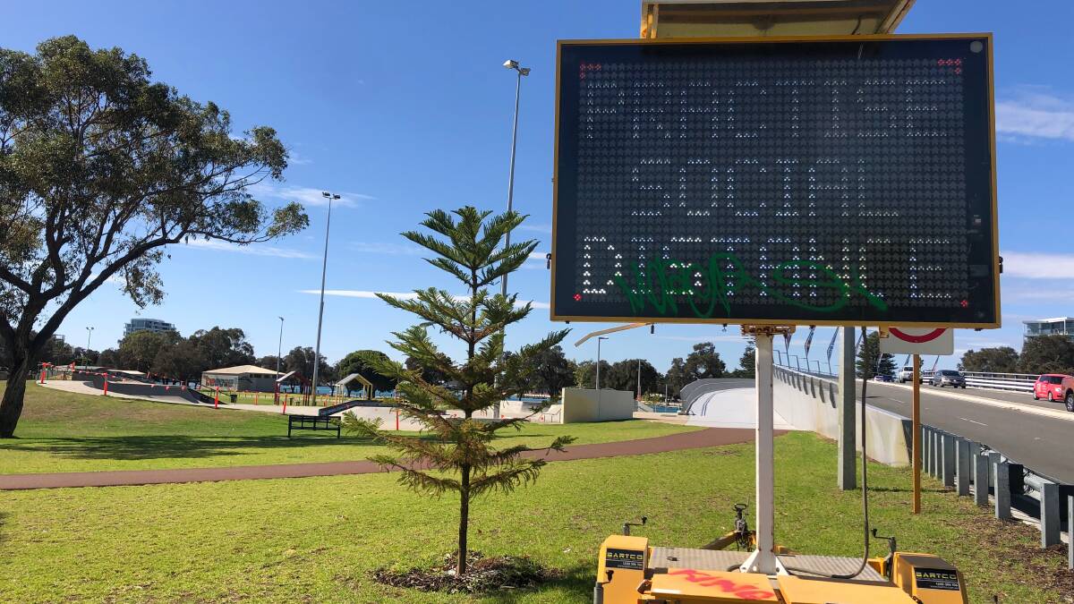 GUIDELINES: A sign near Hall Park at the entrance to the Mandurah Bridge encourages residents to practise social distancing. Mandurah now has 29 virus cases. Photo: Daniela Cooper