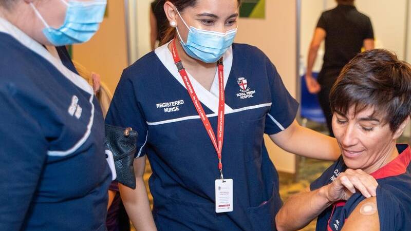 Nurse Antonia Garza (right) was among frontline workers to receive the Pfizer vaccine jab in Perth. Photo: Supplied.