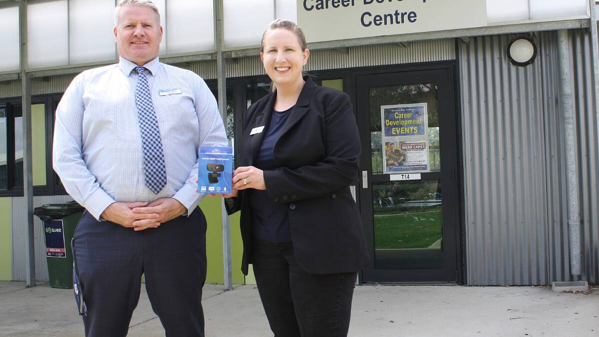 Webcam: Comet Bay College Principal Jamie Hayres proudly accepts the College's new webcam from Defence Health Community Relationships Officer (WA) Lauren Gallagher.