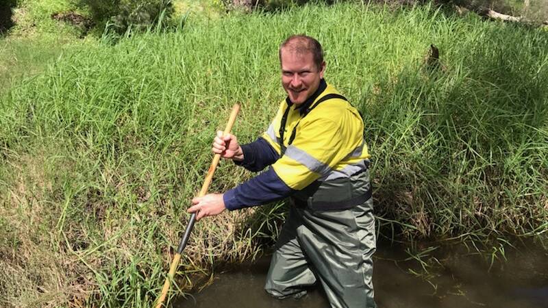 RIVER HEALTH: Environmental scientist Joel Batten uses a sweep net as part of a recent assessment.