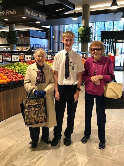Helping hand: Foundation Christian College student Jack Mountain helps shoppers at the Mandurah Forum.
