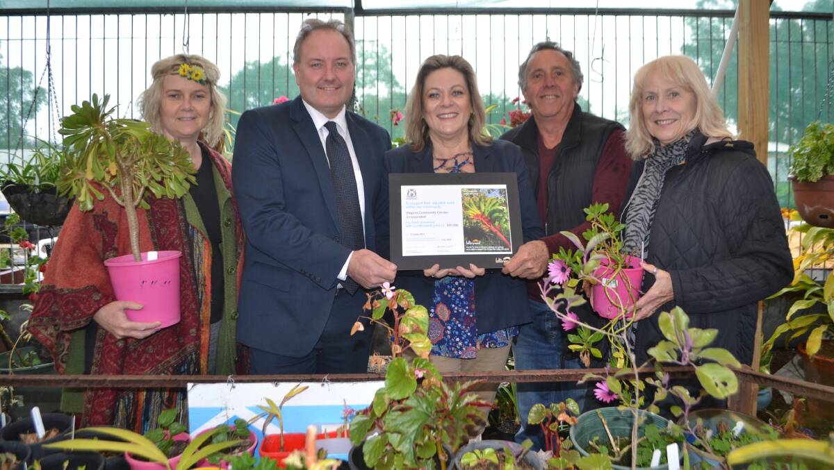 Roots in the community: Pinjarra Community Garden volunteers Nic Willis (left) and Bev Fraser (right) with Shire of Murray chief executive Dean Unsworth, Murray-Wellington MP Robyn Clarke and group chairman Peter Luck. Photo: Gareth McKnight.