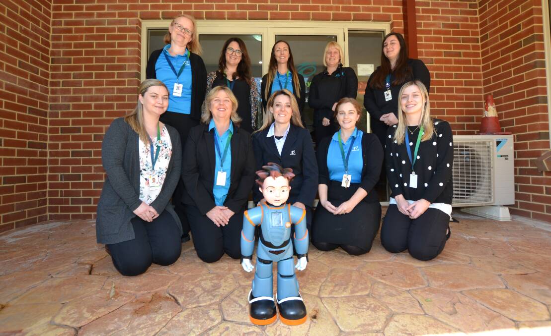 Milestone: Members of the Rocky Bay Mandurah team with Milo - a tool to help children living with autism to develop and practice critical social skills. Photo: Gareth McKnight