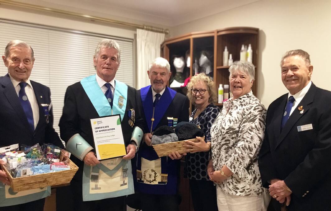 Helping hand: Peel Districts Lodge present Dot’s Place Peel with a wig library donation. Pictured are Arthur Turvey, Michael Banks, Peter Shiner, Cancer Council volunteers Carol and Bronwyn, and and Mike Jones. Photo: Supplied.