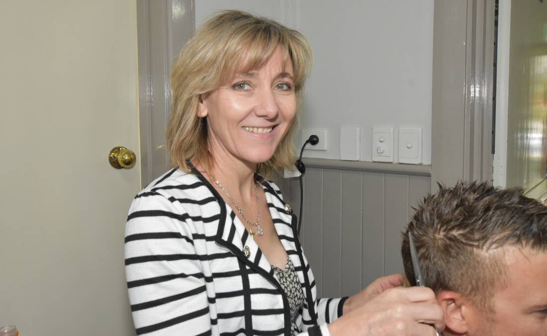 Debbie Gourd volunteers her time at Halo's soup kitchen, giving free haircuts to those in need. Photo: Amy Martin. 