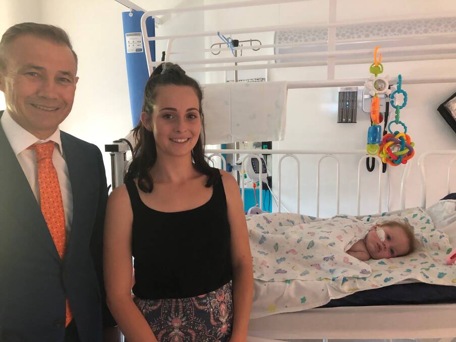 Health Minister Roger Cook with Chelsea Cocking and daughter Tahlea. The eight-month-old is recovering from W strain meningococcal in Perth Children's Hospital. The Geraldton family face months of recovery ahead.