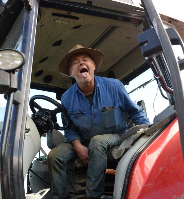 LETTING GO: Farmer Chris Wills doing the lion pose on his tractor. He says most yoga poses can be adapted to be performed on farms. Photo: Rachael Webb
