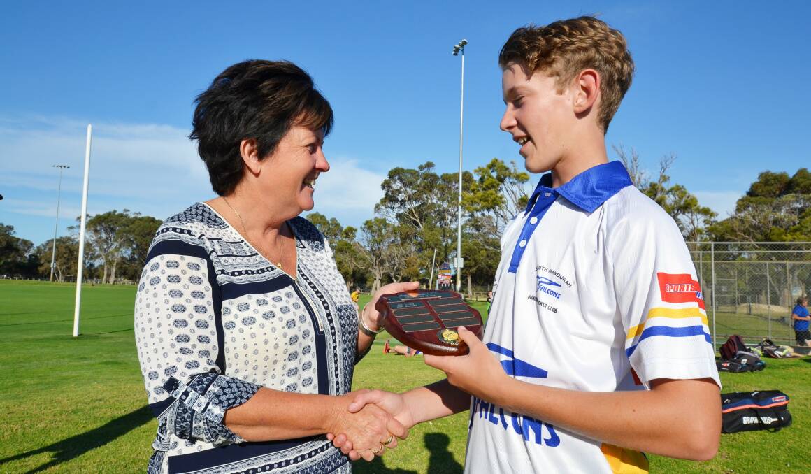 South Mandurah Junior Cricket Club president Julie Boyd presents Wian Kruger with his plaque for becoming the club's first 1000-run scorer. Photo: Justin Rake. 