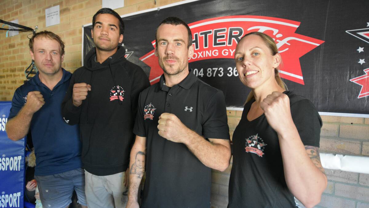 Tyler Naidoo (second left) celebrates his win with Fighter Fit Boxing coaches Bryce Savell, Danny Heyes and Kelly Heyes. Photo: Justin Rake. 