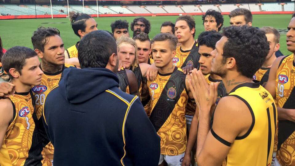Barry Lawrence coaching the Footy Means Business program team in a curtain raiser to Dreamtime at the 'G in 2016. Photo: Supplied.